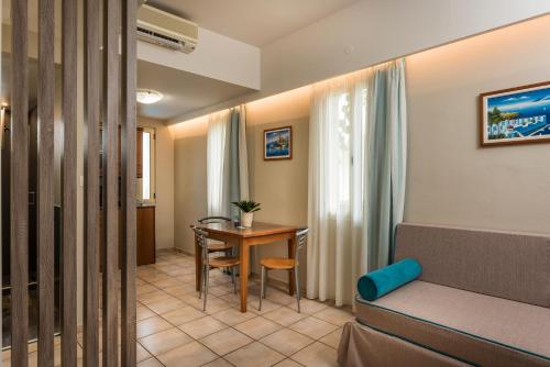 a living room with a couch and a table at Elotis Suites in Agia Marina Nea Kydonias