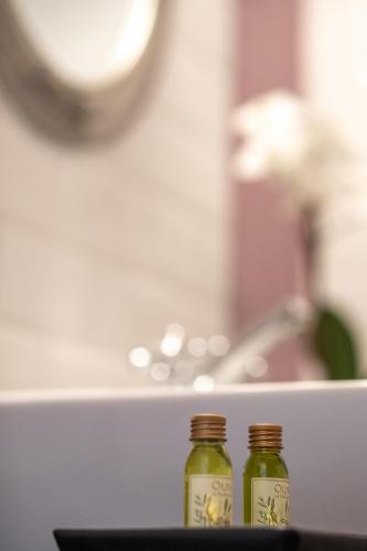 two bottles of green liquid sitting on a table at Tarnóca Kúria in Soponya