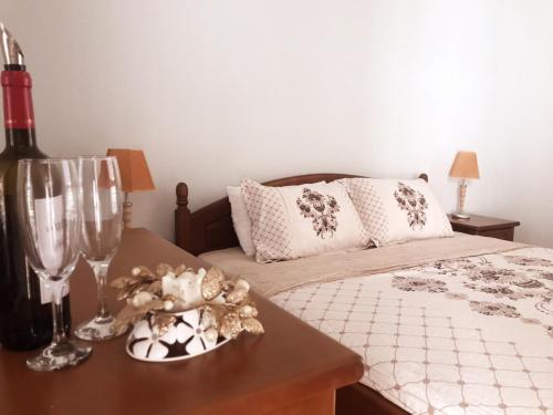 a bedroom with a bed and a table with wine glasses at Sun City 1 - Family Apart Complex in Sunny Beach