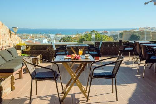 a patio with a table and chairs on a roof at Lagos Uptown Bed & Breakfast in Lagos