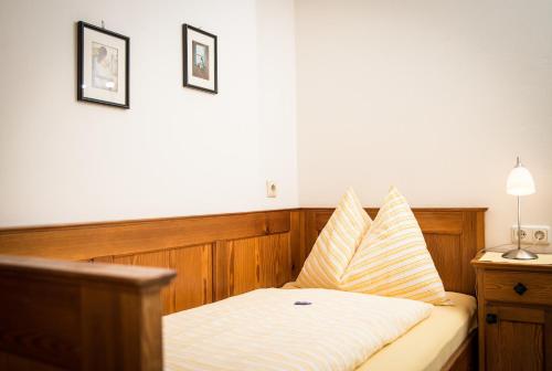 a bedroom with a bed with two pillows on it at Gästehaus Haffner in Zell am See