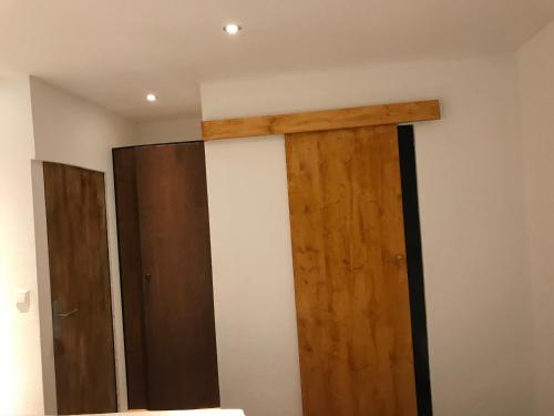 a room with two wooden doors on the wall at TU Ferienzimmer in Ulm Stadtmitte in Ulm