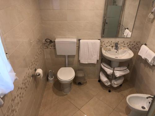 a bathroom with a toilet and a sink at Hotel Chopin in Fiumicino