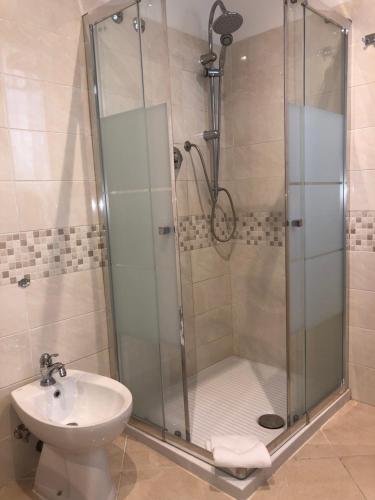a bathroom with a shower and a sink at Hotel Chopin in Fiumicino