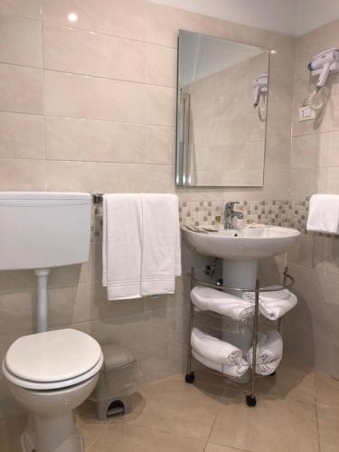 a bathroom with a toilet and a sink at Hotel Chopin in Fiumicino