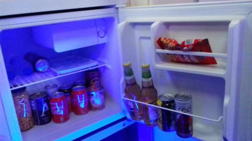 an open refrigerator filled with lots of drinks and soda at SLEEPBOAT Barco Hotel in Porto
