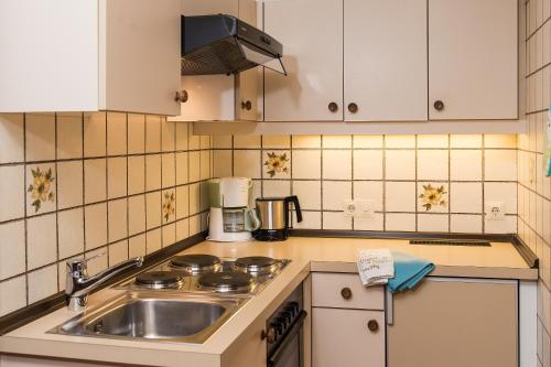 a kitchen with a sink and a counter top at Gästehaus Haffner in Zell am See