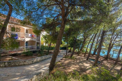 a house with a view of the water and trees at Lavica Seaside Apartments, Podstrana in Podstrana