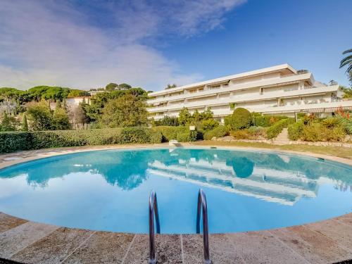 a large swimming pool in front of a building at Apartment Les Hortensias by Interhome in Cannes