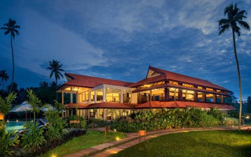 a large building with a lot of windows at Niraamaya Wellness Retreats Backwaters And Beyond Kumarakom in Kumarakom