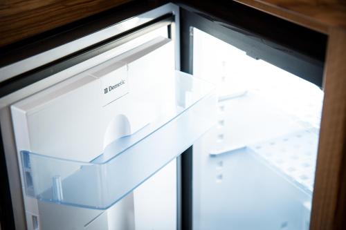 an open refrigerator freezer next to a window at Gästehaus Haffner in Zell am See