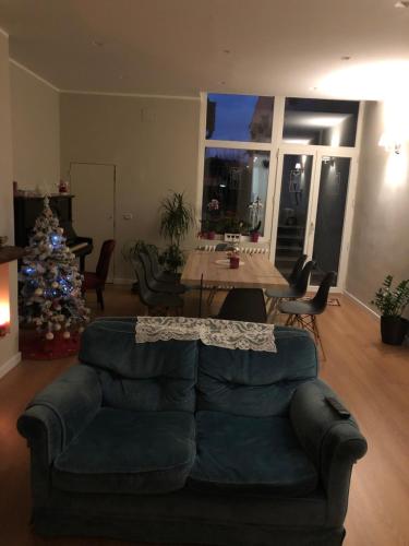 a living room with a couch and a christmas tree at Boutique Hotel Palazzo Corso Umberto in Boiano