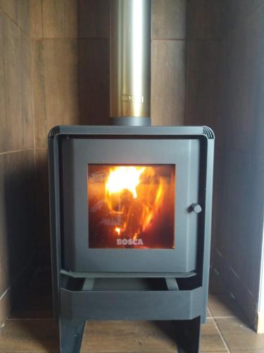 a stove with a fire inside of it at Ribera Cochrane, Cochrane in Cochrane