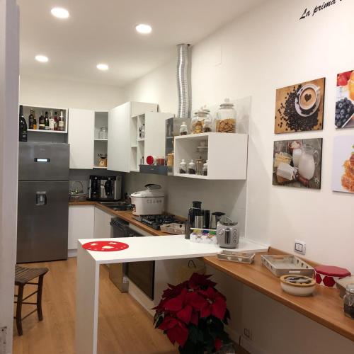 a kitchen with white cabinets and a white counter top at Boutique Hotel Palazzo Corso Umberto in Boiano