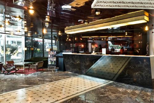 a restaurant with a counter and a bar at The Marmara Pera in Istanbul