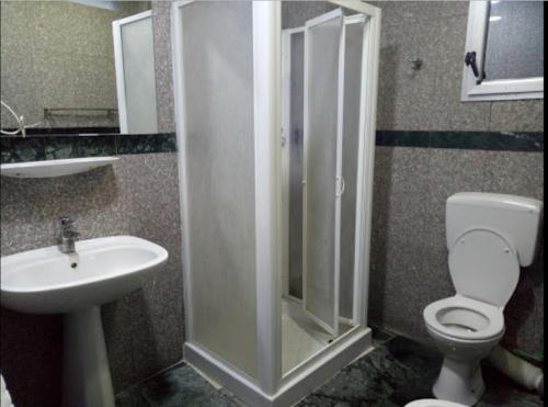 a bathroom with a shower and a toilet and a sink at HOTEL ZIDANE in Sétif