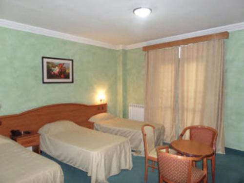 מיטה או מיטות בחדר ב-HOTEL ZIDANE