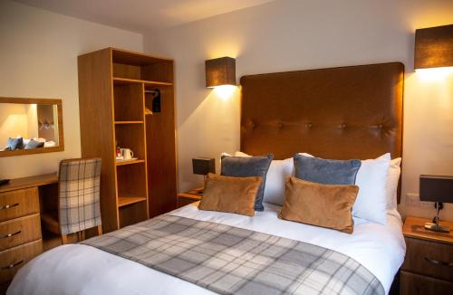 a bedroom with a large bed with two pillows at Harbour House in Ullapool