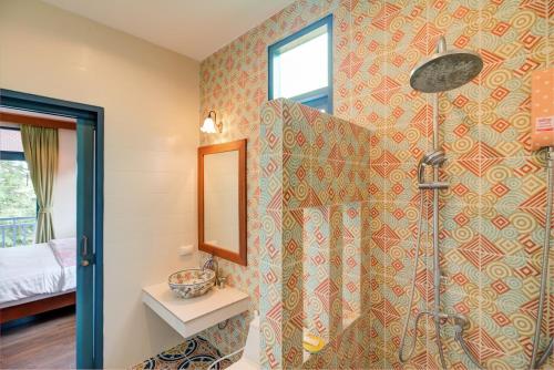 a bathroom with a shower with a shower curtain at Baan Patcharintorn Samui in Chaweng
