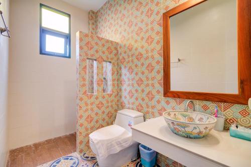 a bathroom with a toilet and a mirror at Baan Patcharintorn Samui in Chaweng