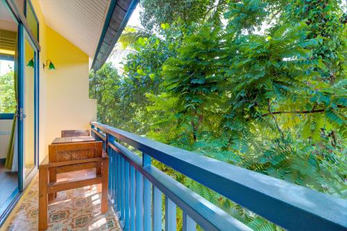 a balcony with a blue fence and a tree at Baan Patcharintorn Samui in Chaweng