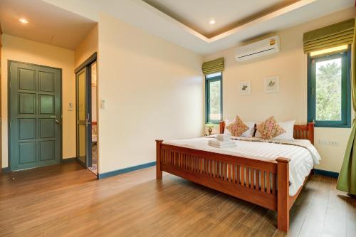 a bedroom with a large bed in a room at Baan Patcharintorn Samui in Chaweng