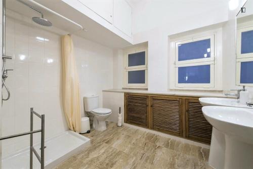 a white bathroom with a sink and a toilet at Saldanha Prestige in Lisbon