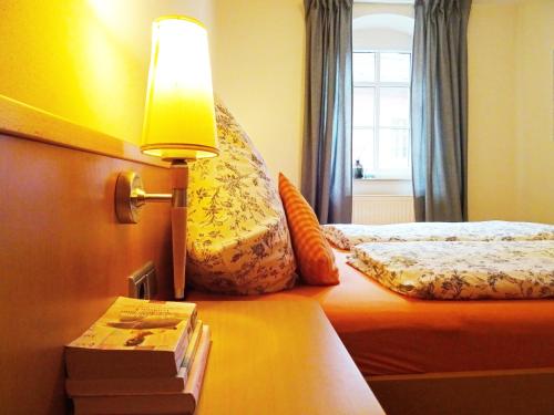 a hotel room with a bed with a lamp on it at Ferienwohnung, Weingut Trockene Schmitts in Randersacker