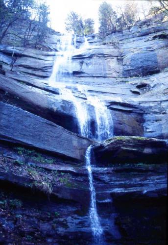 a waterfall on the side of a rocky cliff at La Casina in Stia