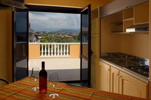 a bottle of wine sitting on a table in a kitchen at Don Antonio Residence in Sellia Marina