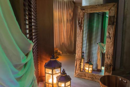 two lights in a room with a mirror at Anatolia Hotel in Thessaloniki