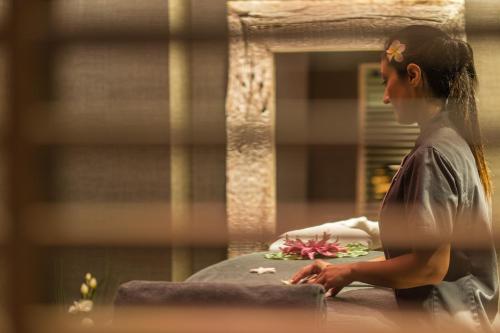 a woman sitting on a table in front of a mirror at Anatolia Hotel in Thessaloniki