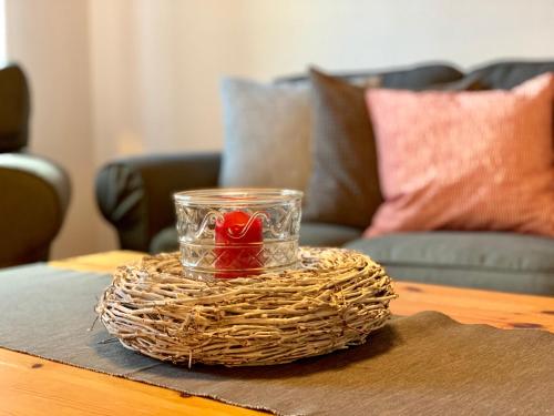 a glass jar with a heart in it on a table at Ferienhof Utech in Wenkendorf auf Fehmarn
