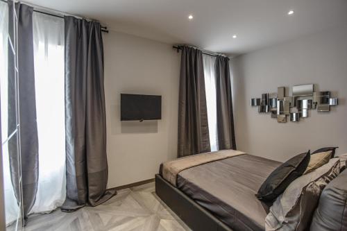 a bedroom with a bed and a flat screen tv at Castle Apartment near Duomo in Milan