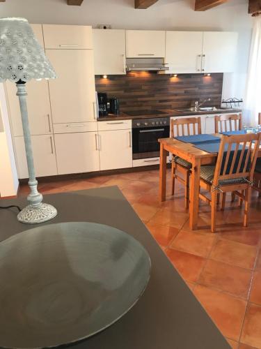 a kitchen with a table and a dining room at Ferienhof Utech in Wenkendorf auf Fehmarn