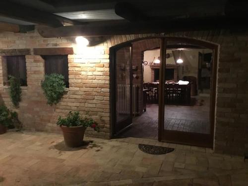 a room with a brick wall and a glass door at La Villa degli Ulivi in Fermo