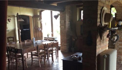 a kitchen with a table and chairs in a room at La Villa degli Ulivi in Fermo