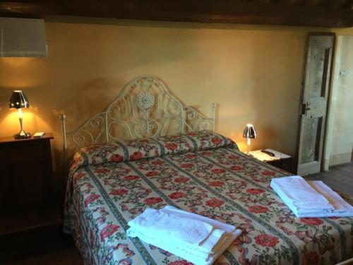 a bedroom with a bed with two towels on it at La Villa degli Ulivi in Fermo