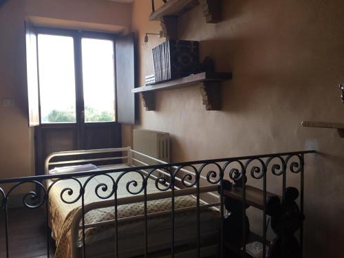 a small bedroom with a bed and a window at La Villa degli Ulivi in Fermo