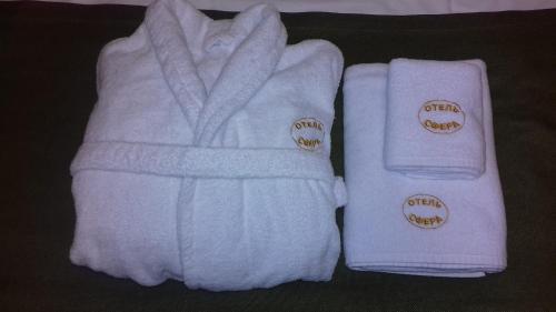 two white towels are sitting next to each other at Sfera hotel Nevsky 163 in Saint Petersburg