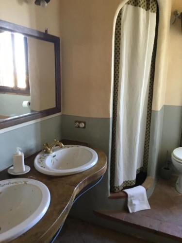 a bathroom with two sinks and a mirror at La Villa degli Ulivi in Fermo