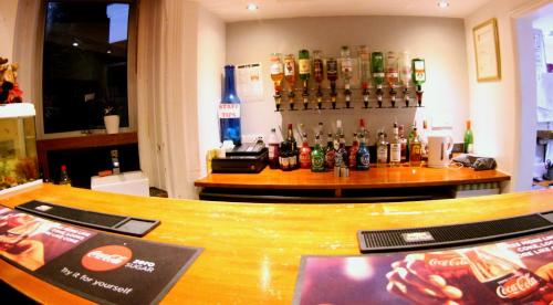 a bar with a lot of bottles of alcohol at Fairmount Hotel in Bournemouth