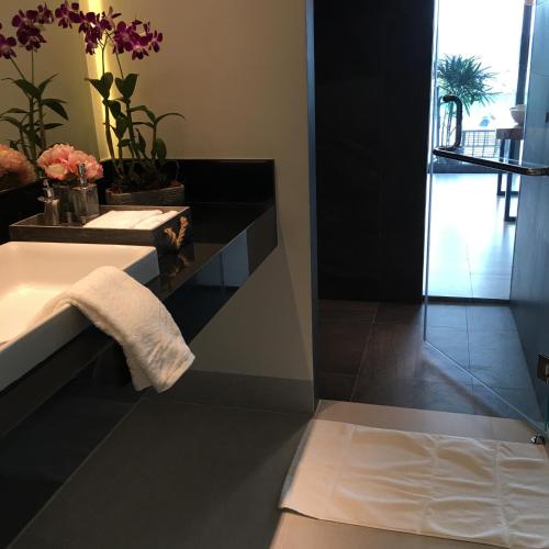 a bathroom with a sink and a towel at Patong Heights in Patong Beach