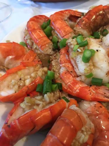 a plate of food with shrimp and vegetables on it at Patong Heights in Patong Beach