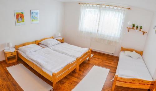 A bed or beds in a room at Penzión Gardoš