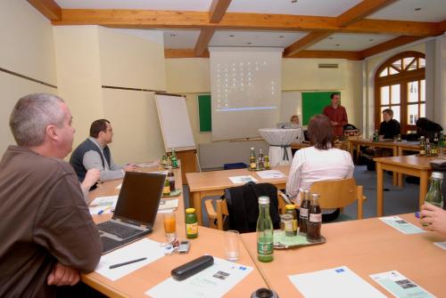 a group of people sitting at tables in a classroom at Villa Bucher - Metnitztalerhof in Friesach