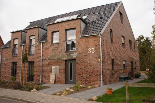 a brick building with the number on it at Bisping33 in Ascheberg