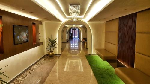 a hallway in a building with a green carpet at Romance Alexandria Hotel in Alexandria
