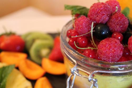 a jar filled with fruits and vegetables on a table at Jägerhof Putzkau in Putzkau