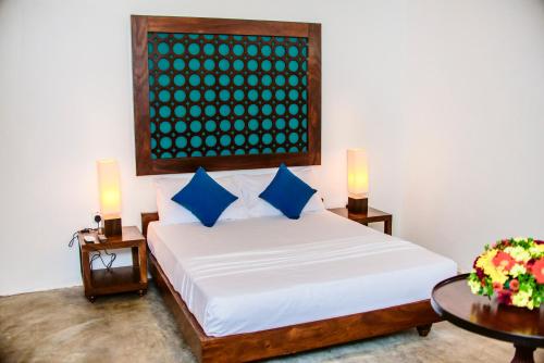 En eller flere senge i et værelse på Thambu Illam